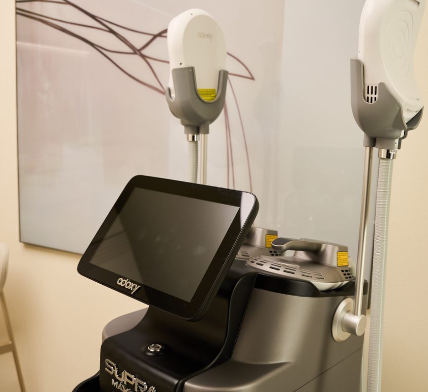 Equipamento de tecnologia com dois cabeçotes e tela, na sala de procedimentos